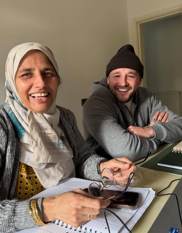 Shagufta Mohammed with a client at her desk